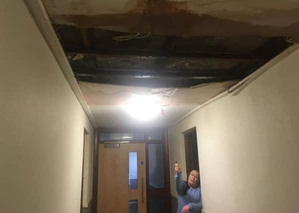 Derby House resident Beatrice Graham at the damaged roof above her flat