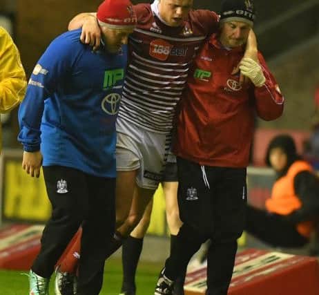 Wigan Warriors' Joe Burgess leaves the pitch with an injury
