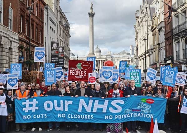 Demonstrators attend a rally in central London, in support of the NHS