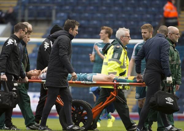 Shaun MacDonald is stretchered off the  field during Latics 1-0 loss to Blackburn on Saturday