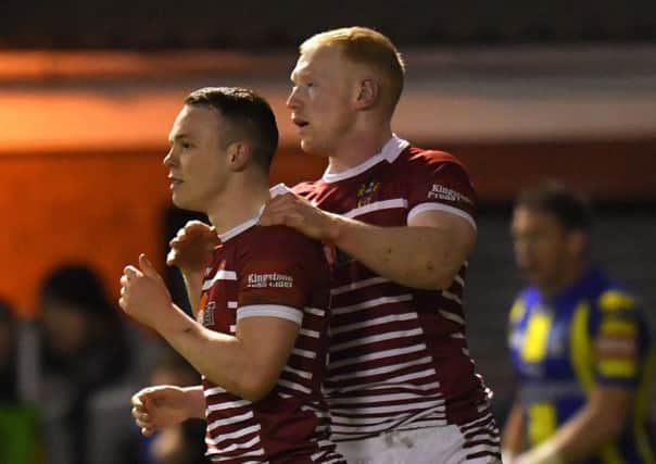 Wigan Warriors' Liam Marshall is congratulated by Liam Farrell