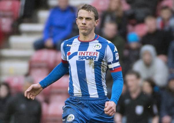 Latics skipper Stephen Warnock, before he limped off in the closing stages