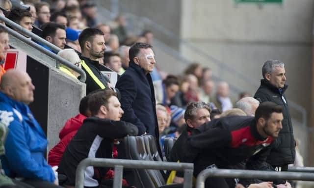 Warren Joyce watches from the stand on Saturday during a damaging 1-0 defeat at the DW Stadium