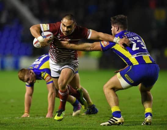 Wigan Warriors' Thomas Leuluai is tackled by Warrington Wolves' Joe Philbin

Betfred Super League match at the Halliwell Jones Stadium, Wigan. Picture by Dave Howarth for BERNARD PLATT. Picture date: Thursday March 9, 2017