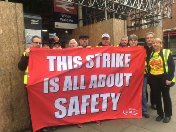 RMT Union members picket outside Wigan Wallgate on Monday, March 13.