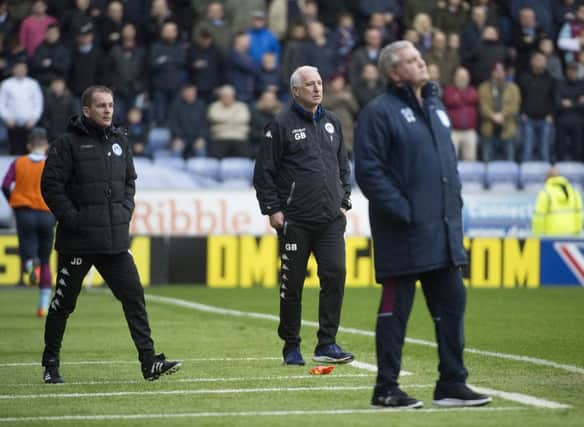 Graham Barrow (middle) watches as Latics lost to Aston Villa on Saturday
