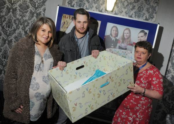 From left, mum-to-be Rebecca Butler and husband Ian with a baby box, pictured with health visitor Katy Warriner at the launch of the Baby Box initiative