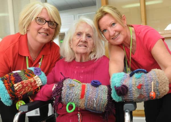 Dementia Friends and support workers from Wigan Central Day Centre, Jackie Taylor, left, and Susan Speakman, right, try out twiddle muffs
