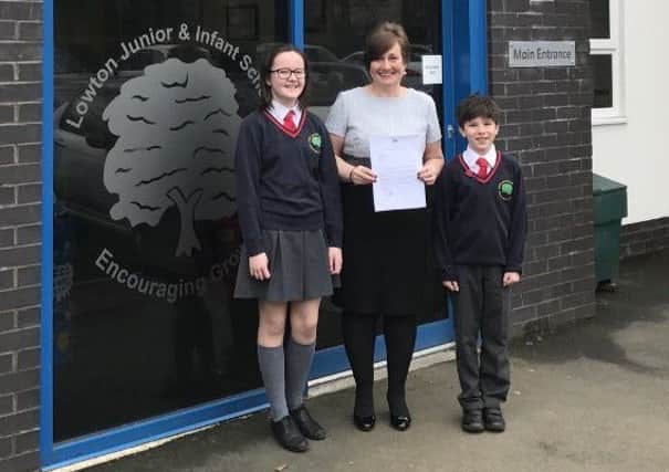 Lowton Junior and Infant Schools head girl Lily Henson, headteacher Alison Davies and head boy Luke Preston with the letter from Nick Gibb MP