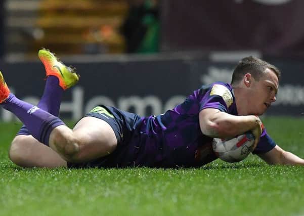 Liam Marshall slides over for a try