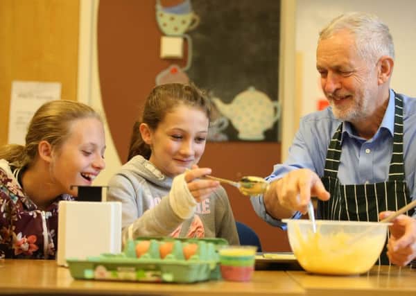 Labour leader Jeremy Corbyn takes part in a cooking session as he visits a childrens holiday club in Lancashire. Labour has proposed free school meals for all primary schools  which will be funded by VAT on private school fees