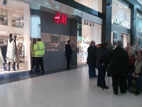 Customers outside H&M after it was closed for flooding
