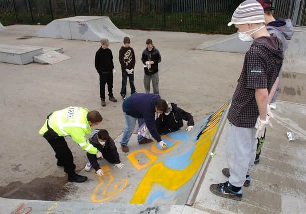 week in pics
Skateboarders don breathing masks to paint their designs on the  Atherton Skate Park behind Hesketh Fletcher High School with help from  PC Andy Wright and artist Martin from the Graffitti Workshop .