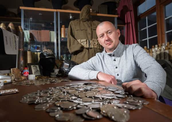 Dan Mackay wants to reunite families with dog tags of Second World War heroes. Photo: SWNS