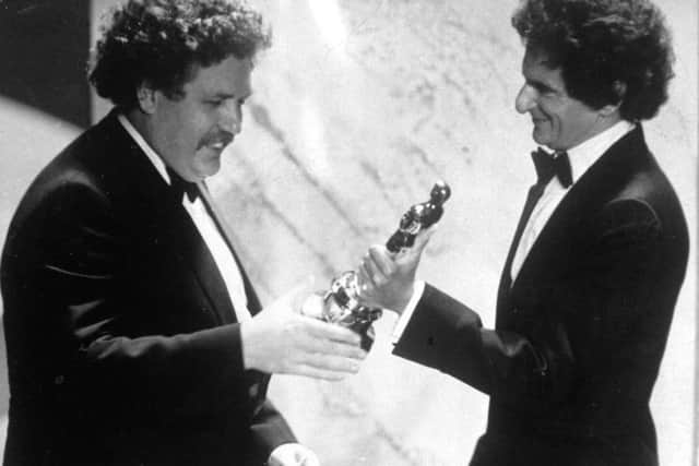 Colin Welland, left, accepts an Oscar for the best screenplay from Jerzy Kosinski, during the 54th annual Academy Awards presentation, Los Angeles