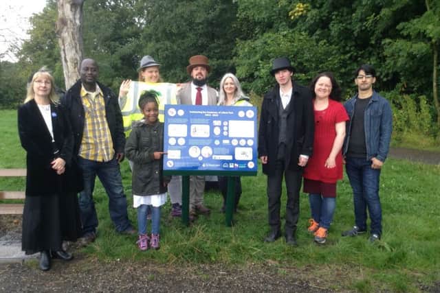 Julie McKiernan (left) and school pupil Ruth Boamah (pointing at her art work) together with Friends of Lilford Park volunteers at the opening of the new heritage panels in Lilford Park
