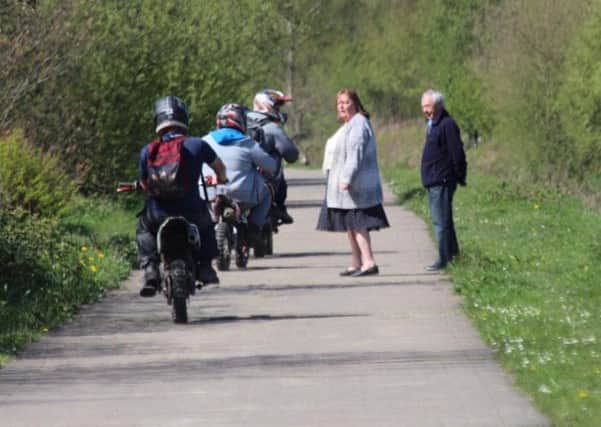 Bikers hurl abuse as they ride past some walkers
