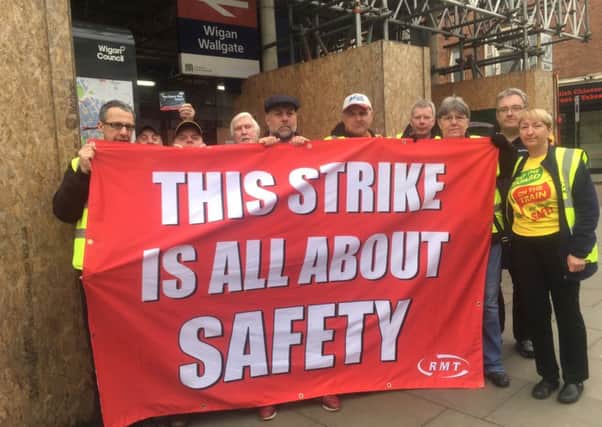 RMT Union members picket outside Wigan Wallgate on Monday, March 13.