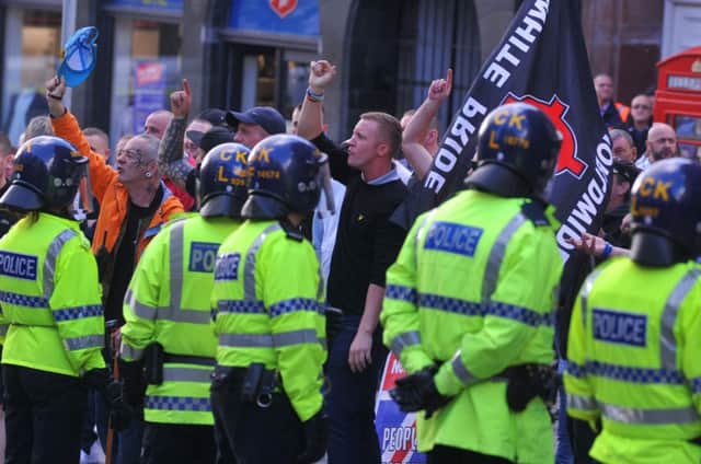 Police at the scene as far-right groups stage an anti-immigration rally in Wigan town centre, as anti-racist protesters rally against their rally.