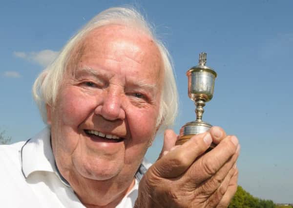 Tom Rathbone, 85, with a replica of the trophy he was awarded after winning of the Wigan Infirmary Charity Cup golf tournament in 1949