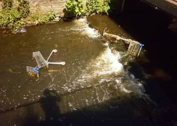 Shopping trollies being dumped in the River Douglas near Tesco in Wigan