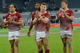 Wigan players applaud the fans