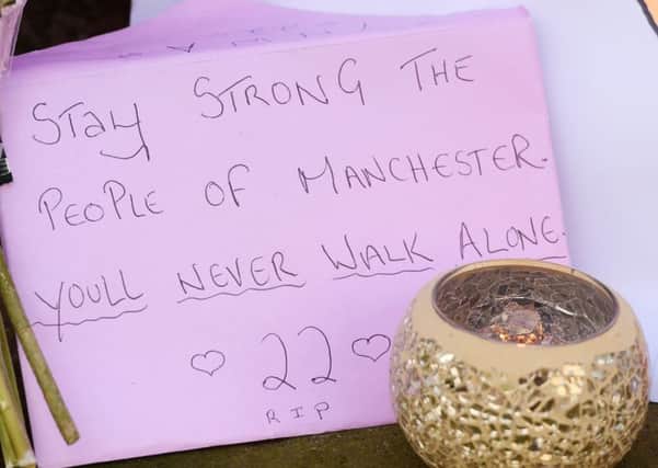 Tributes left outside St Ann's Church in Manchester. Ben Birchall/PA Wire