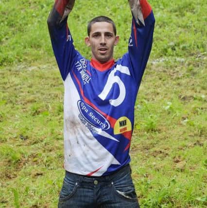 Chris Anderson wins the men's race during the annual unofficial cheese rolling at Cooper's Hill in Brockworth, Gloucestershire, where a cheese has been chased down the 200 yard, one-in-three gradient hill, annually, since the early 1800s