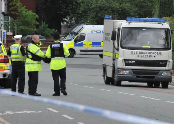 Police at the scene as Wigan Lane, Wigan and other roads were closed to motorists and evacuated as the bomb disposal unit were called to a property being searched by police on Springfield Street, Wigan