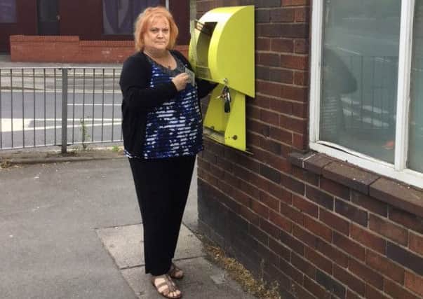 Debbie Parkinson with the damaged defibrillator cabinet on Wigan Road in Standish