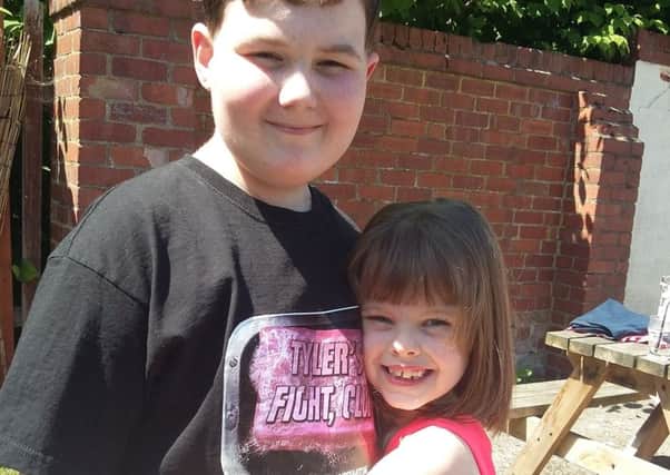 Tyler Yates and Megan Coard, who had her hair cut short to raise money for an appeal to send him to the USA for treatment for brain tumours