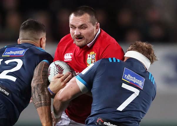 British and Irish Lions captain Ken Owens is tackled by Blues' Sonny Bill Williams (left) and Blake Gibson