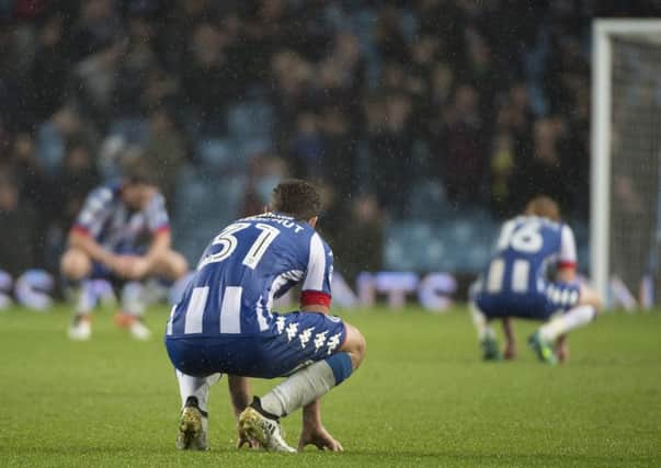 Wigan Athletic's players after another defeat