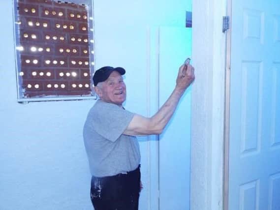 Eric Lancaster, who is 85, volunteering to paint the toilets at Lilford Park in Leigh