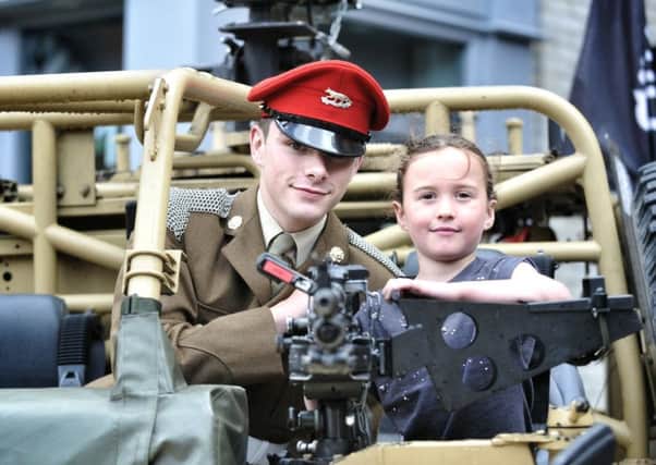 Picture by Julian Brown 25/06/16

Trooper Luke Gribbin shows Abbygale Hogarth (6) the workings of a RWMIK Armoured Vehicle 

National Armed Forces Day, Wigan