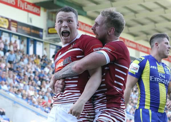 Liam Marshall celebrates his try with Sam Tomkins
