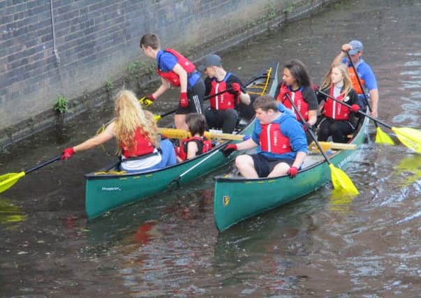 Youngsters from the Dean Trust clean up a stretch of Leeds-Liverpool Canal as part of Wigan Athletic's Community Trust scheme