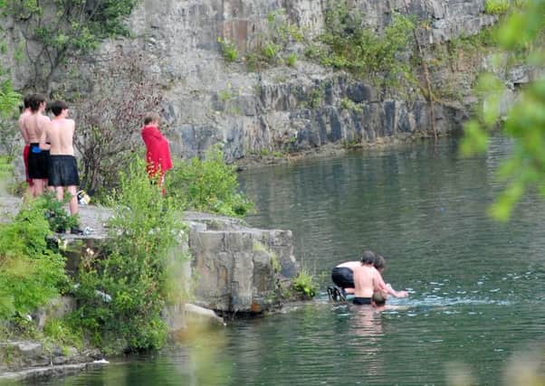 Youngsters pictured playing at the Appley Bridge quarry last year despite repeated safety warnings from police