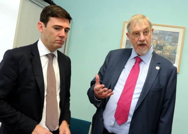 Mayor of Greater Manchester Andy Burnham, left, announces Leader of Wigan Council Lord Peter Smith, right, as the region's lead for health and social care, as they meet staff at Wigan Infirmary's Integrated Discharge Hub