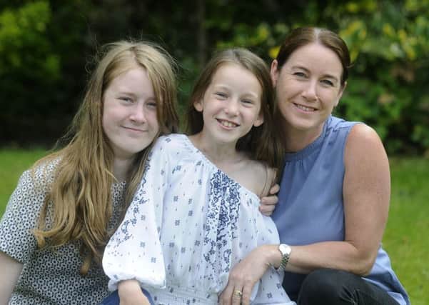 Ten-year-old Emma Hoolin with sister Lily, 14, and mum Jill