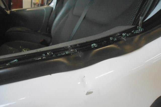 The smashed window of the van
