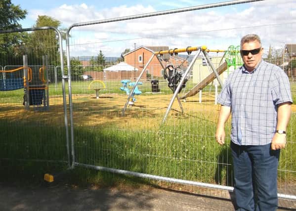 Coun Ray Whittingham at the fenced-off play area on Woodhurst Drive in Standish