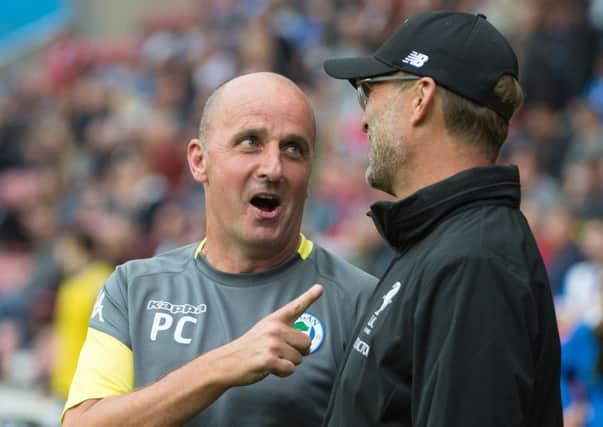 Paul Cook chats with Jurgen Klopp during Friday's game