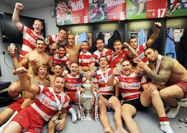 Warriors players celebrate 
beating Hull FC in the 2013 
Challenge Cup Final.