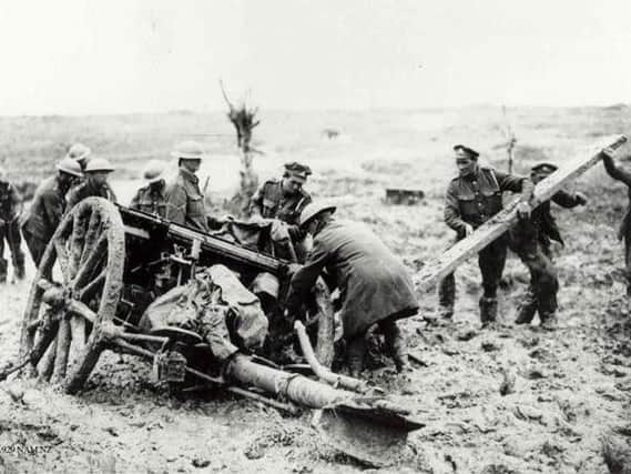 Graphic illustration of the terrible the conditions as soldiers struggle to extract a gun from the mud during the battle at Passchendaele