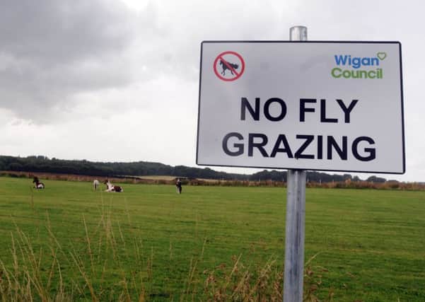 Horses roam free around Bryn Gates playing fields, off Bolton Road, Bamfurlong - with signs warning 'no fly grazing'
