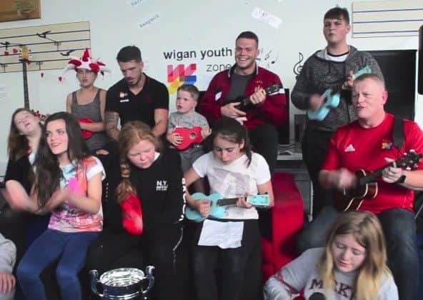Wigan Youth Zone members and Paul Holden sing along the new Warriors knockout cup final song