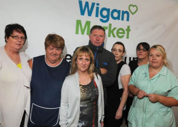 Janet Ryding, centre, with a group of market traders who feel let down by Wigan Council and Greater Manchester Police after reporting many incidents of abuse and criminal damage over the past few months at Wigan Indoor Market
