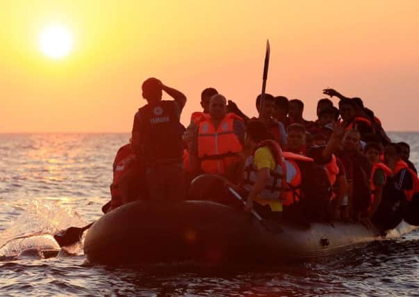 Migrants and refugees on a boat approaching the Greek island of Kos