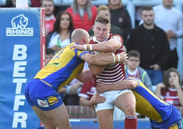 George Williams is tackled by the Leeds defence
